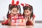 Two cute asian child girls surprise with gift boxes