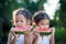 Two cute asian little child girls eating watermelon fresh fruit