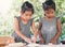 Two cute asian little child girls prepare a dough for baking