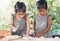 Two cute asian little child girls prepare a dough for baking