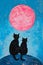 Two cute black cats sitting on a crescent moon against a beautiful blue sky background