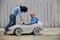 Two Cute boy plays with a toy car