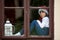 Two cute boys, brothers, looking through a window, waiting for S