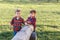 Two cute brother boys tweens having fun outside at sunset in the country