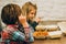 Two cute children eats spaghetti pasta in fast food restaurant