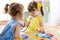 Two cute children playing doctor and hospital using stethoscope. Friends girls having fun at home or preschool.