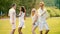 Two cute couples hanging out at open-air festival, dancing to music, having fun