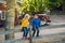 Two cute funny Caucasian children boy girl sitting on wooden rustic fence in park farm outside