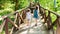 Two cute girlsare heading to the family camp along the eco trail of the reserve. A beautiful wooden road in the mountain forest