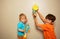 Two cute kids play with rockets drawn on paper