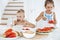 Two cute kids preschooler eating fresh juicy watermelon and ice-cream