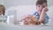 Two cute little boys having fun at the tea table with pastry