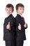 Two cute little boys twins in business suits thumbs up