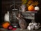Two cute little gray rats plays into Still life composition in vintage style with antique lantern, pumpkins, bunch of garlic and