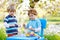 Two cute little kid boys wearing Easter bunny ears, painting colorful eggs and having fun outdoors. Family, siblings