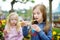 Two cute little sisters drinking frozen slushie drink