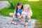 Two cute little sisters painting on stones together