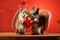 Two cute red squirrels holding a red heart