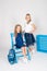 Two cute schoolgirls in a beautiful trendy school uniform with a backpack, books and notebooks with blue chair