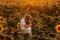 Two cute sibling boys hugging and having fun sunflowers field. Adorable friends together on warm summer day. Brother love concept.