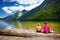 Two cute sisters enjoying the view of deep green waters of Konigssee, known as Germany`s deepest and cleanest lake, located in th