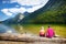 Two cute sisters enjoying the view of deep green waters of Konigssee, known as Germany`s deepest and cleanest lake, located in th