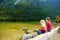 Two cute sisters enjoying the view of deep green waters of Konigssee, known as Germany`s deepest and cleanest lake, located in th