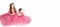 Two cute sisters in evening bright identical pink dresses on a white background.Little princess