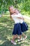 Two cute smilling little girls posing in front of their school.