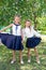 Two cute smilling little girls posing in front of their school.