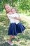 Two cute smilling little girls posing in front of their school.