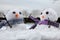 Two cute snowmen wearing scarfs and twigs for arms