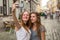 Two cute teen girls girlfriend take a selfie on smartphone outdoors in the old town.