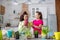 Two cute teens looking amused while planting flowers