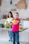 Two cute teens planting flowers in the kitchen