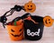 Two Cute Trick or treat loot bags with spider and pumpkin head boppers. Concept of Boo kids scary trick-or-treating