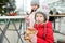 Two cute young sisters eating Czech trdelnik on traditional Christmas fair in Vilnius, Lithuania. Children enjoying sweets,