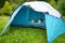 Two cute young sisters playing in a tent on a campsite. Active lifestyle, family recreational weekend, summer outdoor