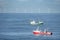 Two cutters passing each other in the North sea with a wind farm in the background