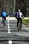 Two cyclists walk on wood road