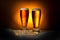 two dark glass frothy beer with ears of wheat on light background, Oktoberfest concept