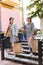 Two dark-haired businesswomen feeling happy after shopping day