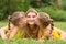 Two daughters kissing mother lying on grass on a picnic, Mother looked up fun