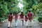 Two daughters, mother, father and grandmother join hands to enjoy a walk together