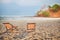 Two deckchair canvas on sand at the tropical beach background