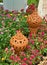 Two decorated clay pots in the flowers garden.