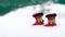 Two decorative christmas boots on snow white background. Christmas holiday background with Santa boots, copy space
