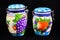 Two Decorative Kitchen Containers With Fruit Painted On Outside