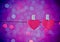 Two decorative red hearts hanging against blue and violet light bokeh background, concept of valentine day