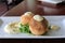 Two delicious crab cakes with lemon caper remoulade served over a bed of arugula